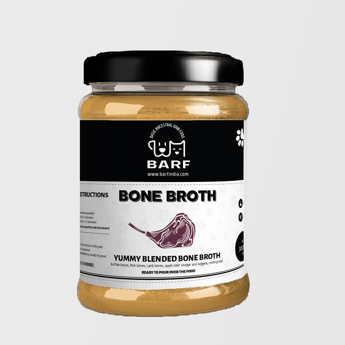 A chilled jar of Yummy Blended Bone Broth for dogs from www.barfindia.com features a black lid, white label with dog and cat logo, ingredient details, bone illustration, and contains light brown broth perfect for dogs.