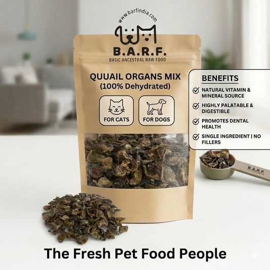 A 60g brown bag labeled "Quail Organ Mix - Cat Treats" from www.barfindia.com sits on a table, with dried organs beside it. These natural treats support cat nutrition and dental health.