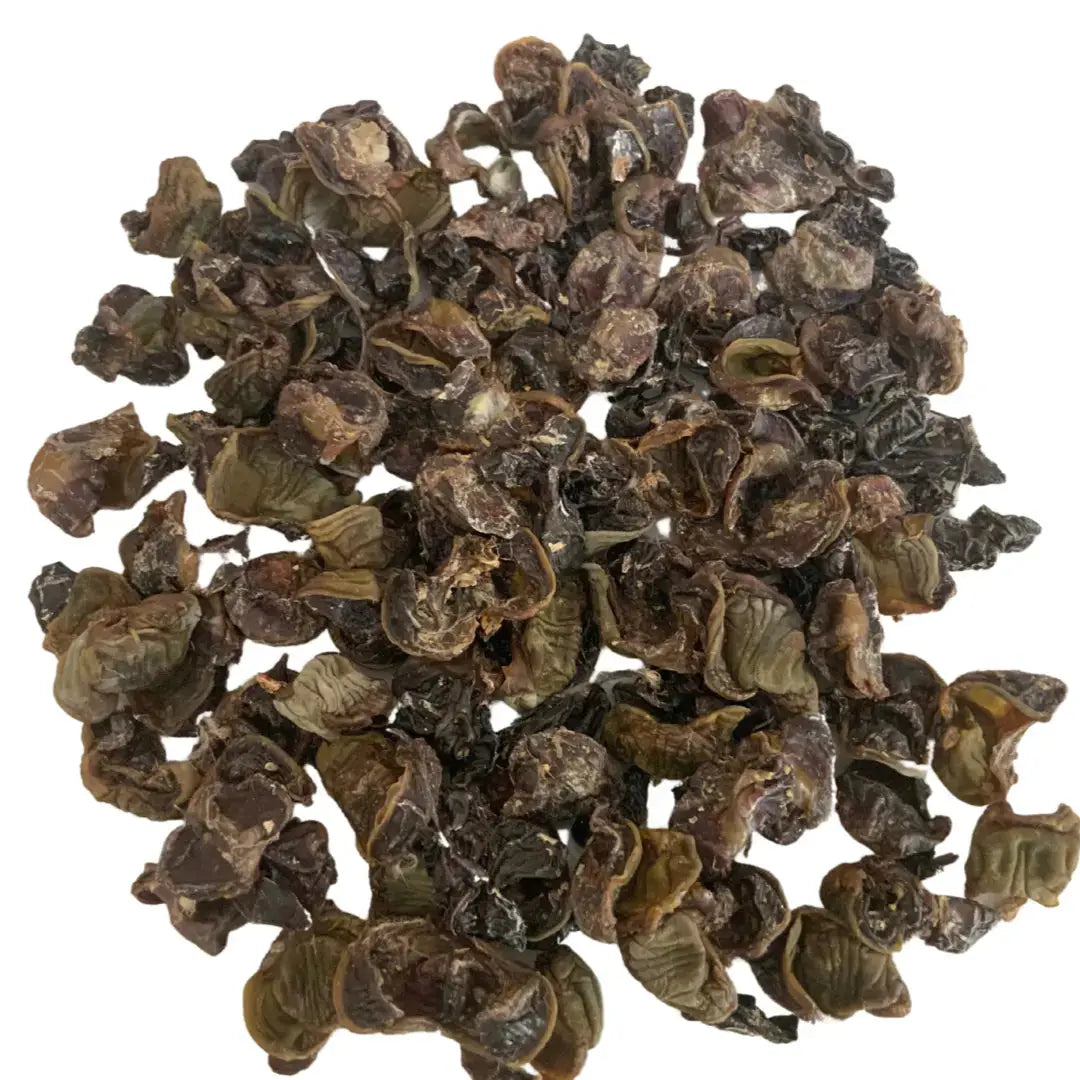 A heap of dried black cardamom pods evokes the look of www.barfindia.com's Quail Organ Mix Cat Treats (60 gms), a novel protein option for cats.